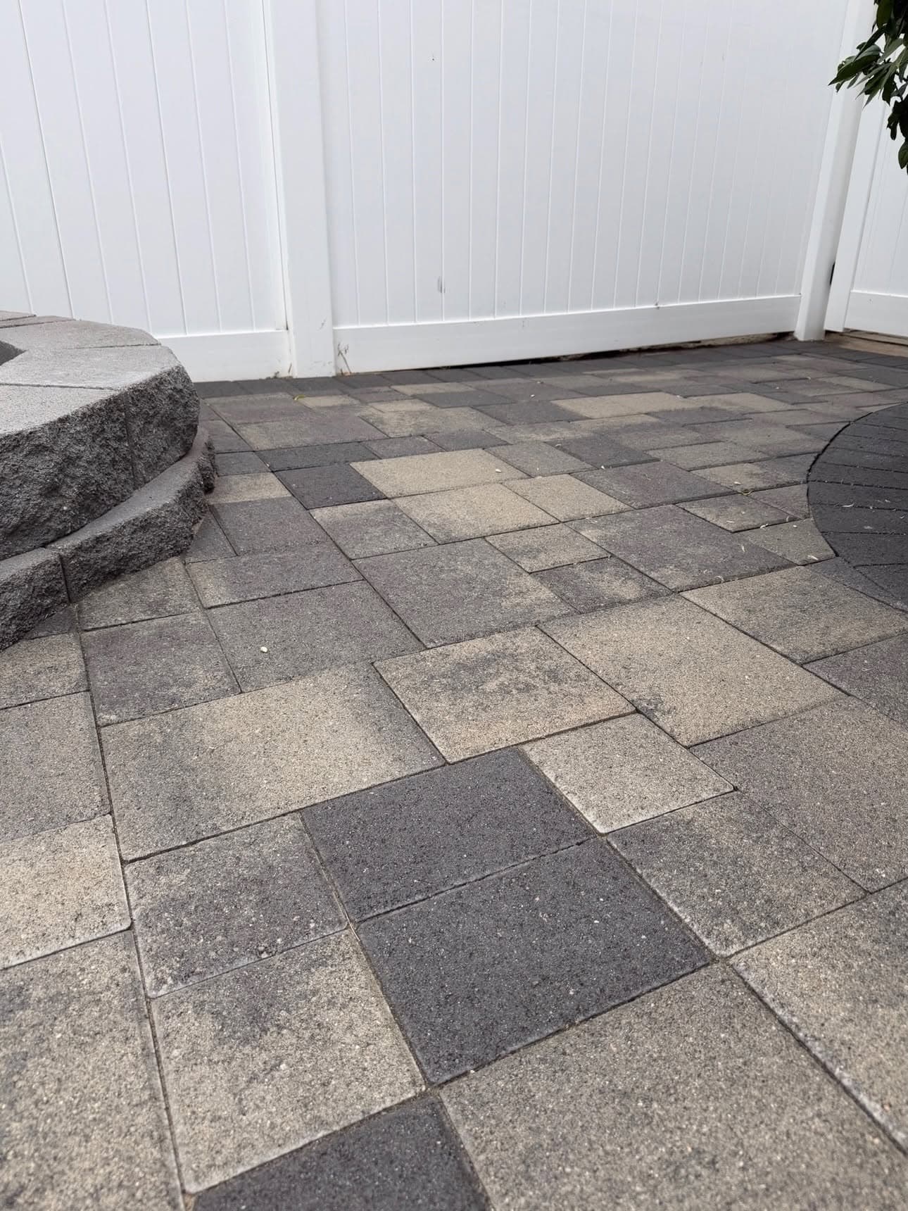 Paver patio after restoration and joint re-sanding in Orange County with stone seat wall