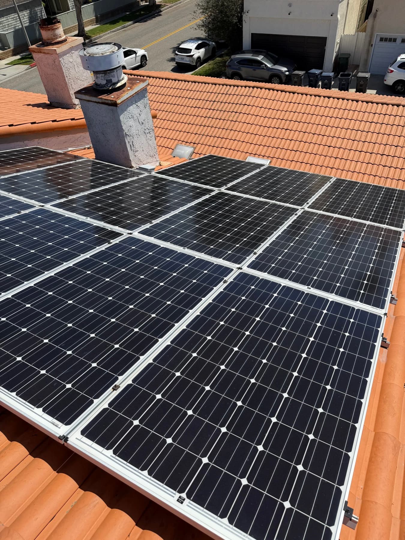 Freshly cleaned solar panels on a Spanish tile roof in Orange County